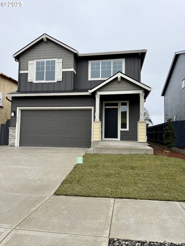 view of front of home featuring a front yard, a garage, and a porch