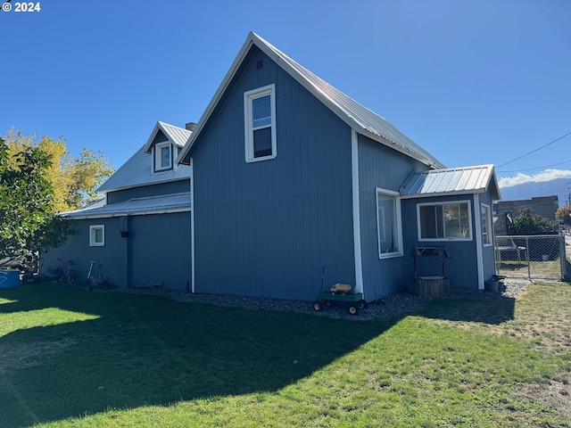 view of side of home with a lawn