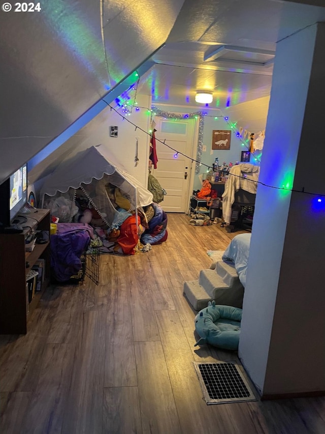 additional living space with lofted ceiling and hardwood / wood-style floors