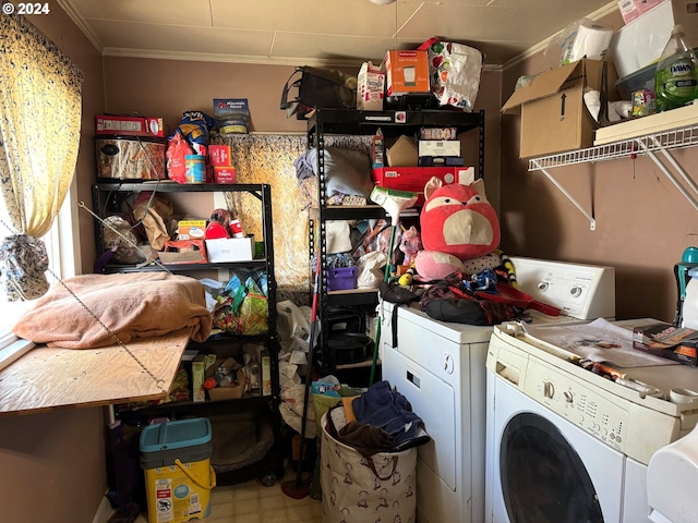 laundry area with washing machine and clothes dryer and ornamental molding