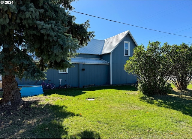 view of home's exterior with a yard