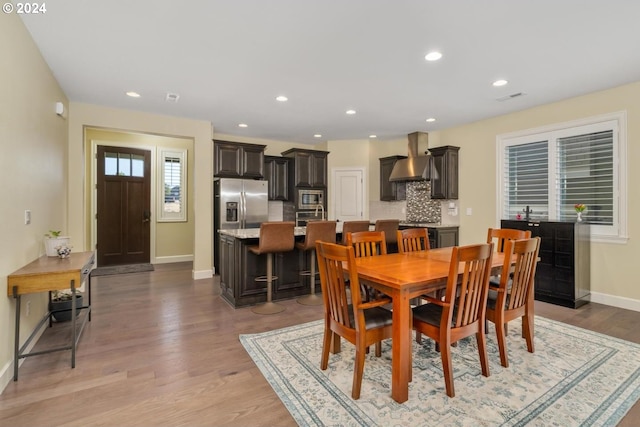 dining area featuring light wood-style floors, baseboards, and recessed lighting
