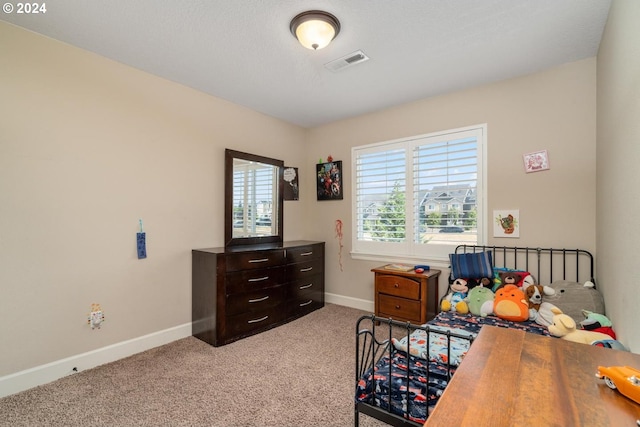 carpeted bedroom with baseboards and visible vents