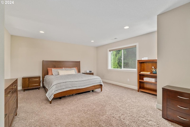 bedroom featuring light carpet, baseboards, and recessed lighting