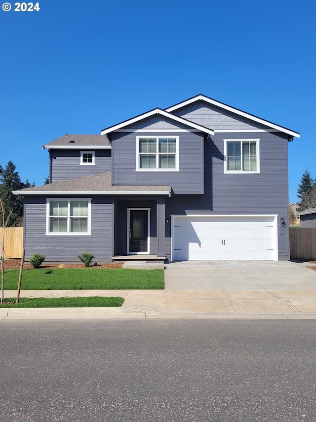 view of front facade with a garage and a front yard