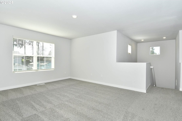 spare room with carpet floors and plenty of natural light