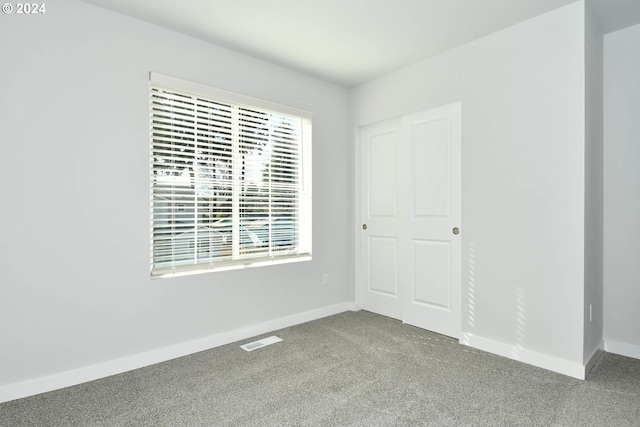 unfurnished room featuring carpet flooring