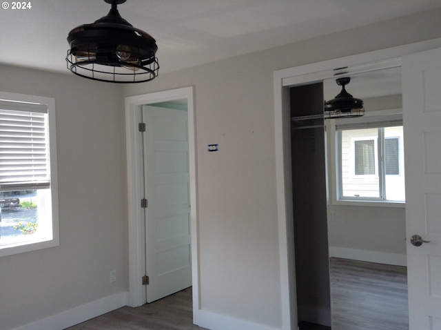 unfurnished bedroom featuring a closet and dark hardwood / wood-style flooring