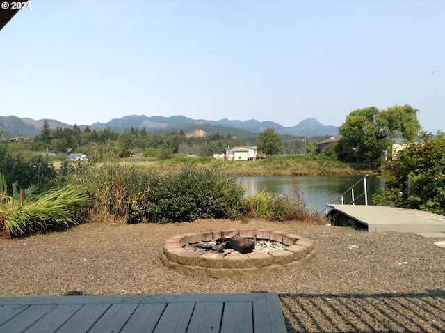 view of community with a mountain view and an outdoor fire pit