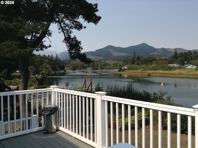 deck with a water and mountain view