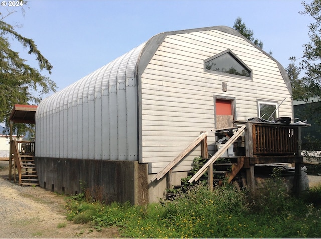 rear view of house featuring a deck