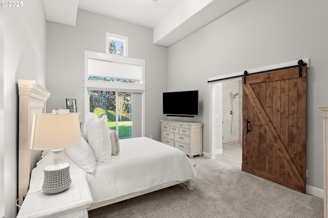 bedroom featuring a barn door, light colored carpet, a high ceiling, and multiple windows