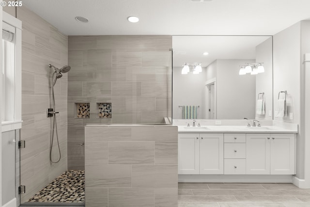 bathroom featuring vanity and a shower with door