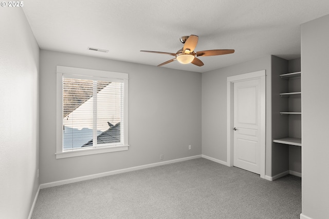 unfurnished bedroom with ceiling fan and light colored carpet