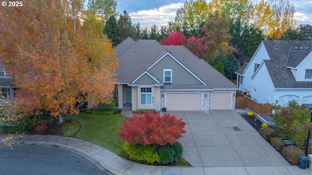 view of front of property with a garage and a front lawn