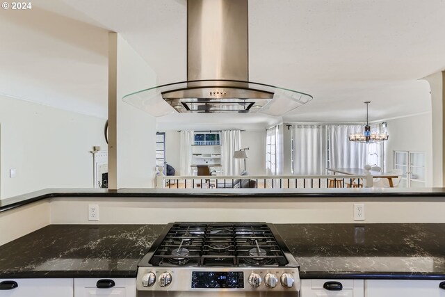 kitchen featuring white cabinets, an inviting chandelier, island exhaust hood, and range