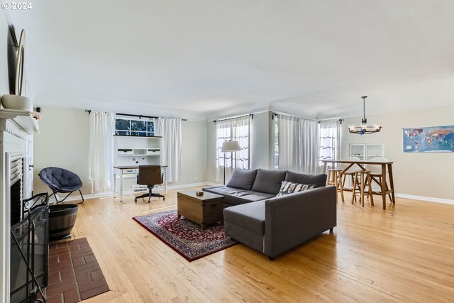 living room featuring an inviting chandelier and light hardwood / wood-style flooring