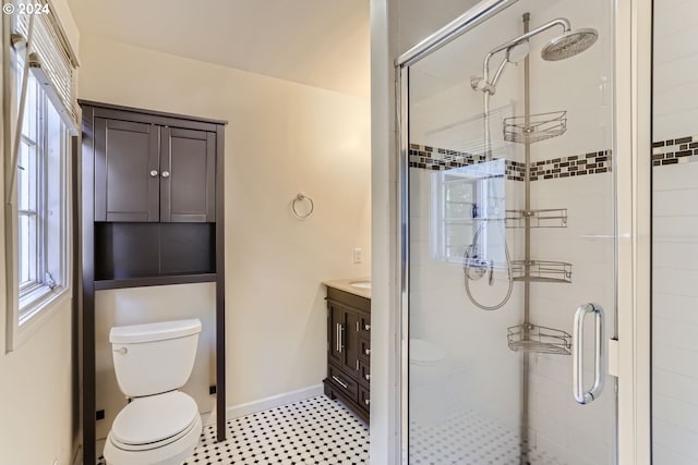 bathroom featuring tile patterned flooring, toilet, an enclosed shower, and vanity