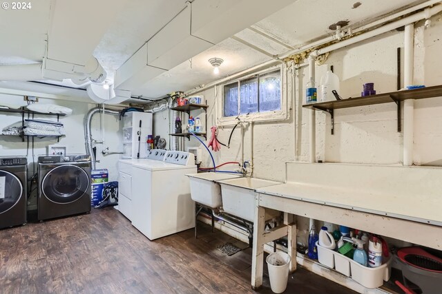 laundry room featuring a workshop area, washing machine and dryer, and dark wood-type flooring