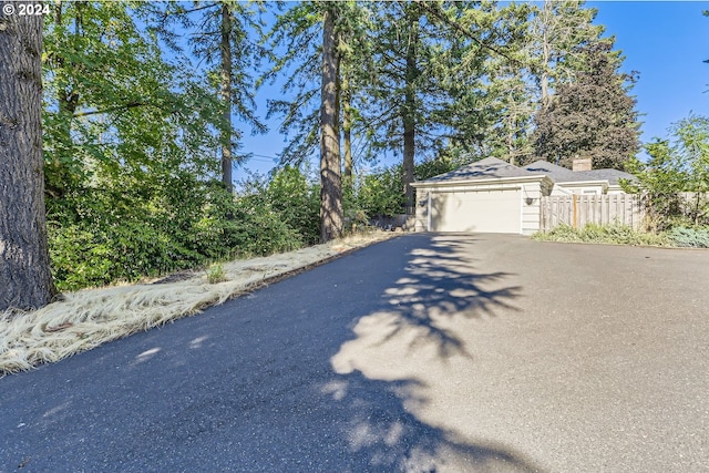 exterior space featuring fence and aphalt driveway