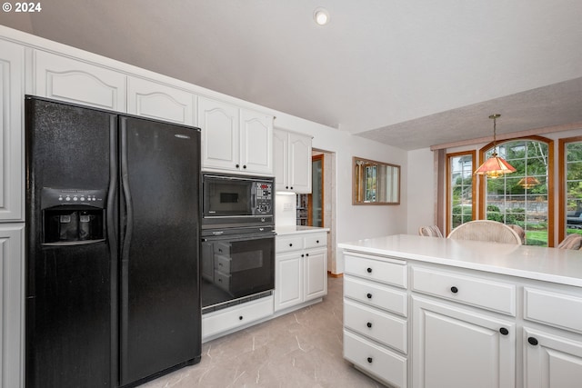 kitchen with black appliances, vaulted ceiling, hanging light fixtures, and white cabinetry