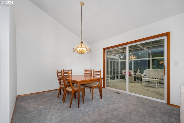 dining space featuring lofted ceiling, carpet, and a chandelier