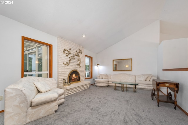 living room with vaulted ceiling, a brick fireplace, and light colored carpet