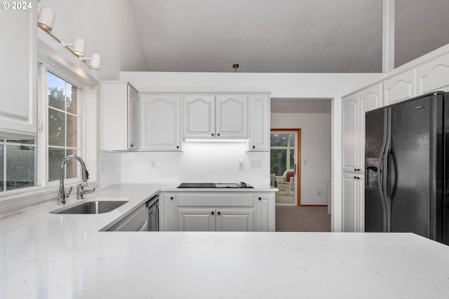 kitchen with black appliances, white cabinetry, and sink