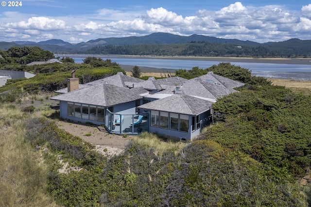 birds eye view of property with a water and mountain view