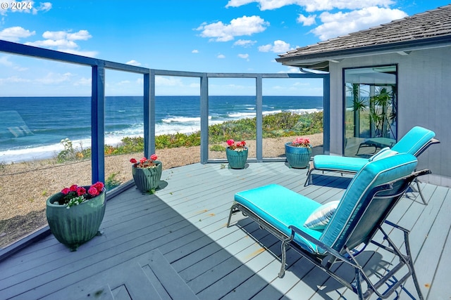 deck with a water view and a beach view