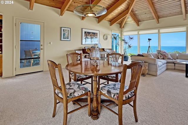 dining room with wooden ceiling, lofted ceiling with beams, light colored carpet, and a water view