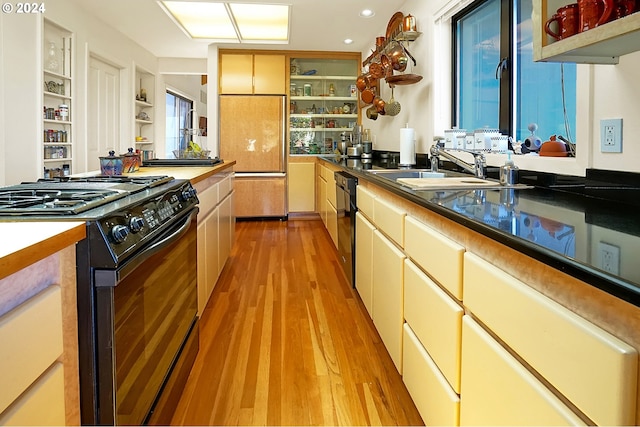 kitchen featuring light wood finished floors, open shelves, recessed lighting, black appliances, and a sink