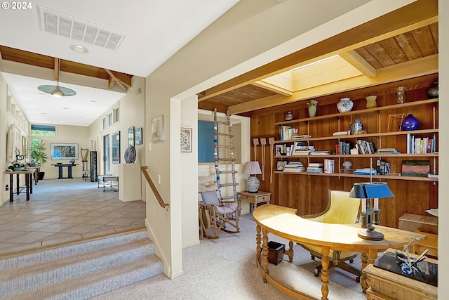 sitting room featuring light carpet, visible vents, a skylight, and light tile patterned floors