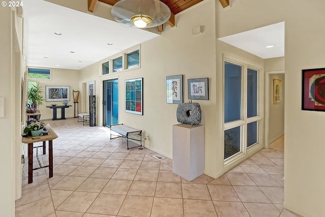 hallway featuring light tile patterned floors, visible vents, and recessed lighting