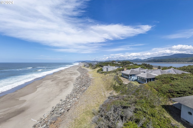 drone / aerial view featuring a water view and a beach view