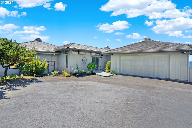 view of front of property featuring aphalt driveway and a garage