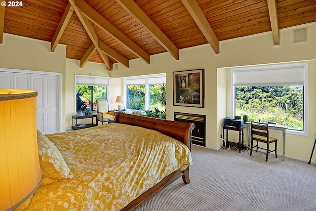 carpeted bedroom featuring wood ceiling, multiple windows, a warm lit fireplace, and vaulted ceiling with beams