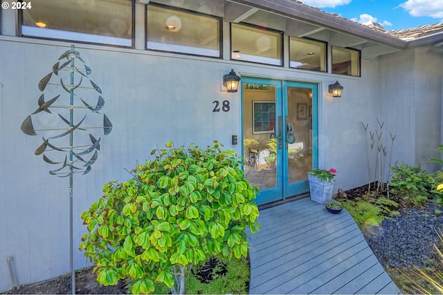 entrance to property with french doors and a wooden deck