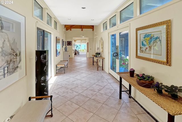 corridor with beamed ceiling and light tile patterned flooring