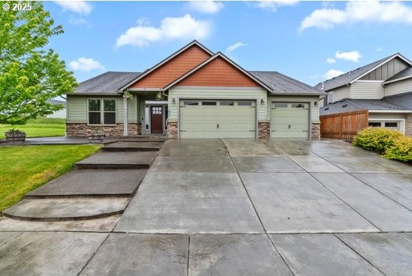 834 N 13th Pl, Ridgefield, WA 98642 - craftsman inspired home featuring a garage, driveway, stone siding, and a front yard