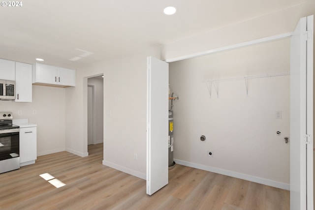 kitchen featuring strapped water heater, light wood-type flooring, electric range, and white cabinetry