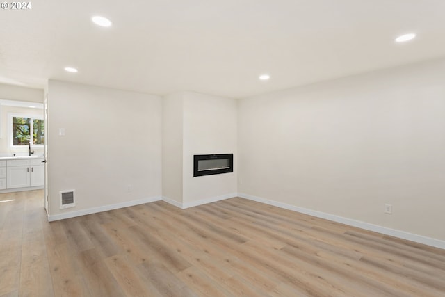 unfurnished living room featuring light wood-type flooring