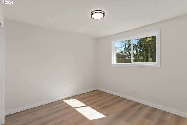 empty room with light hardwood / wood-style flooring