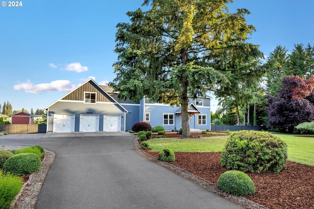 view of front of home with a front yard and a garage