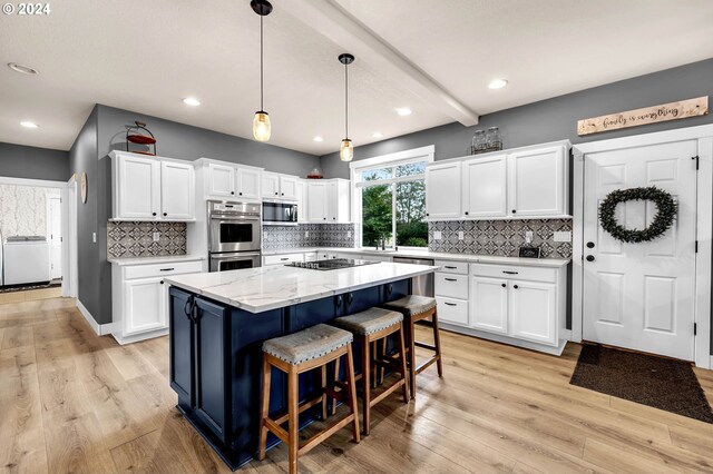 kitchen featuring white cabinets, appliances with stainless steel finishes, and a kitchen island