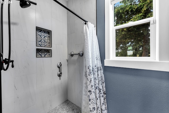 bathroom with walk in shower and a wealth of natural light