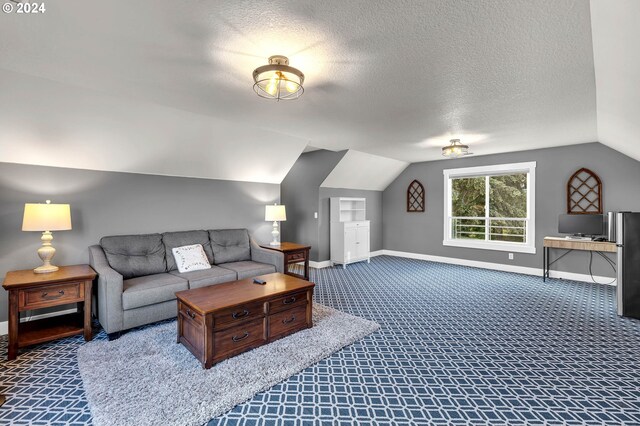 living room with vaulted ceiling, a textured ceiling, and carpet floors