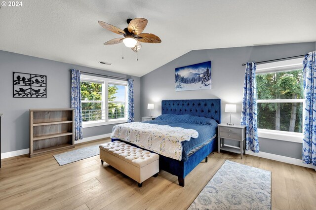 bedroom featuring light wood-type flooring, ceiling fan, and vaulted ceiling