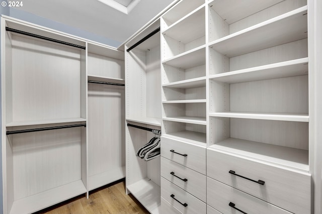 walk in closet featuring light hardwood / wood-style flooring