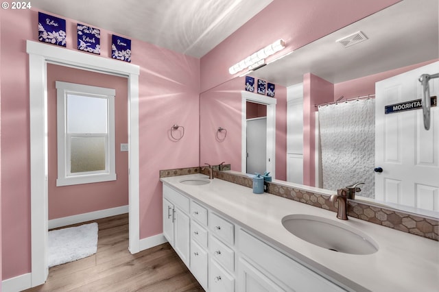 bathroom with hardwood / wood-style flooring and vanity